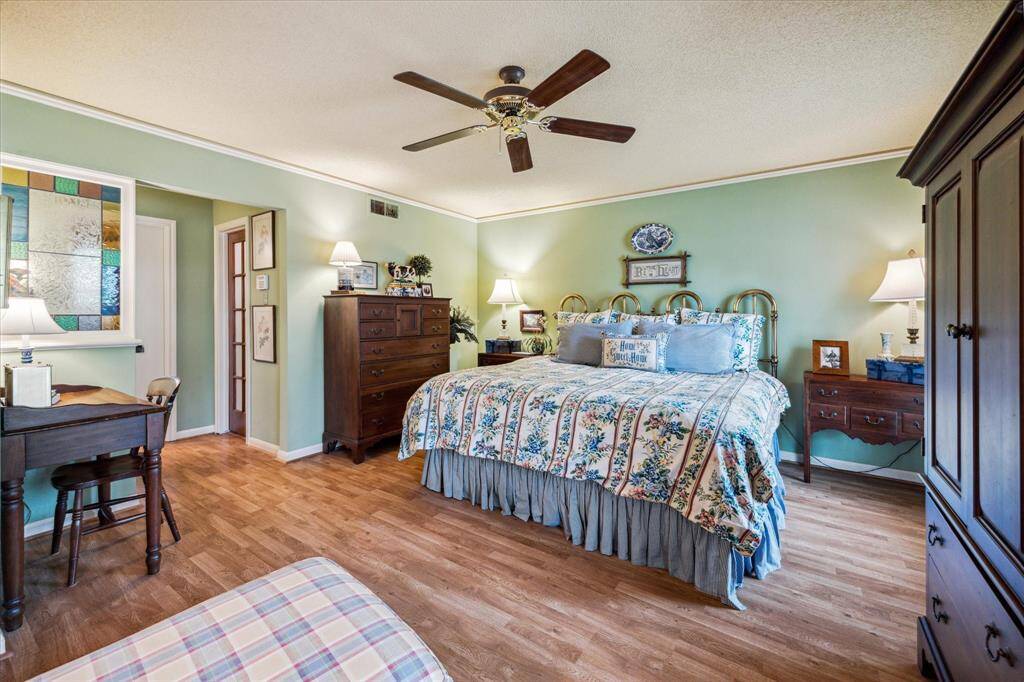 Convenient access to one of two walk-in closets provides ample storage and everyday functionality. This inviting space blends comfort and style, creating a peaceful retreat within the home.