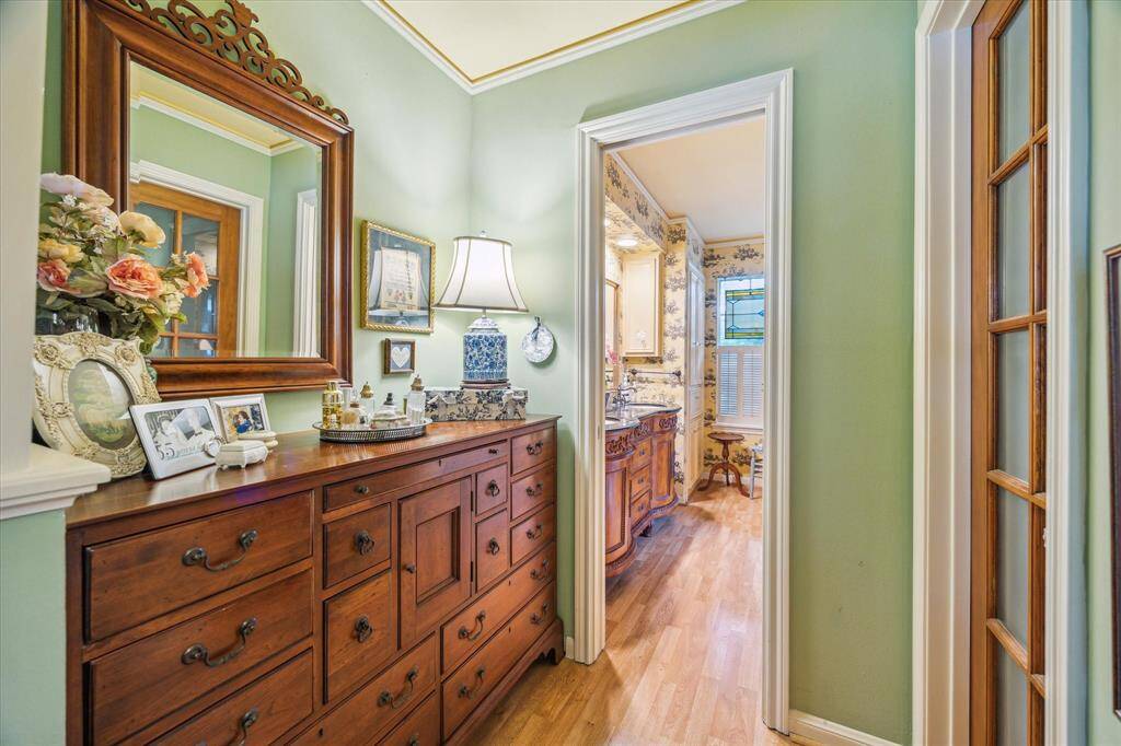 Just outside the primary bath, a dedicated dressing area offers added convenience and privacy, complete with access to one of two spacious walk-in closets. This thoughtfully designed space is perfect for getting ready in comfort and keeping everything organized.
