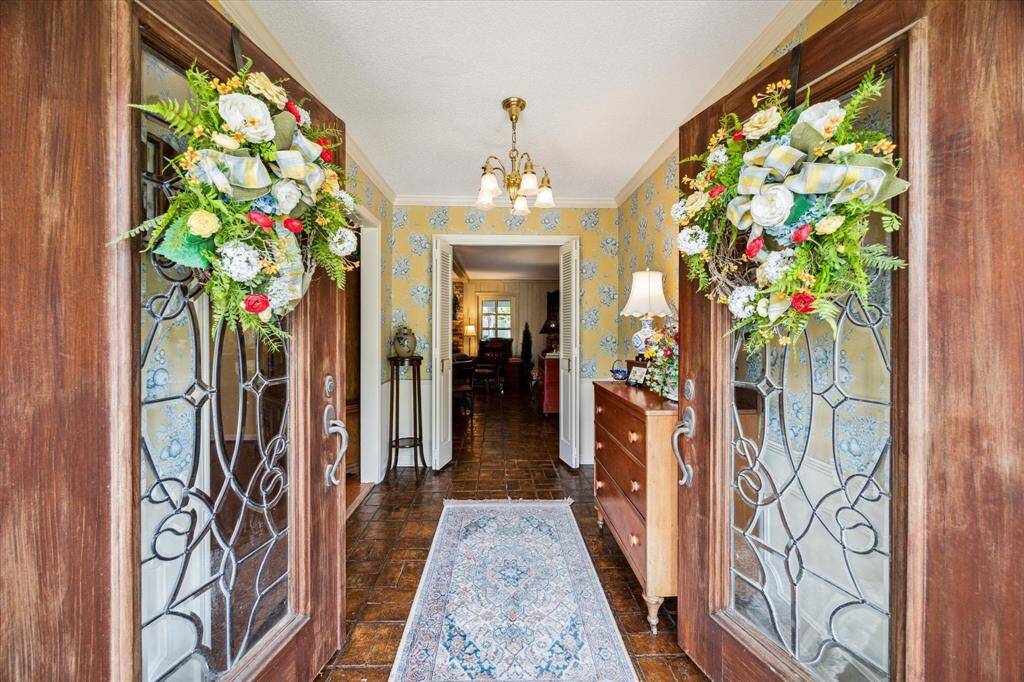 Elegant double leaded glass front doors welcome you into a bright and inviting entryway, where natural light filters through intricate glasswork, creating a stunning first impression. The doors not only provide a touch of timeless sophistication but also offer privacy while allowing soft illumination to flow into the space.