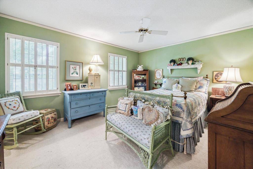 Large secondary bedroom offering a generous layout that can easily accommodates a full bedroom set while still providing room for a desk. The walk-in closet adds exceptional storage, perfect for keeping the space tidy and organized.