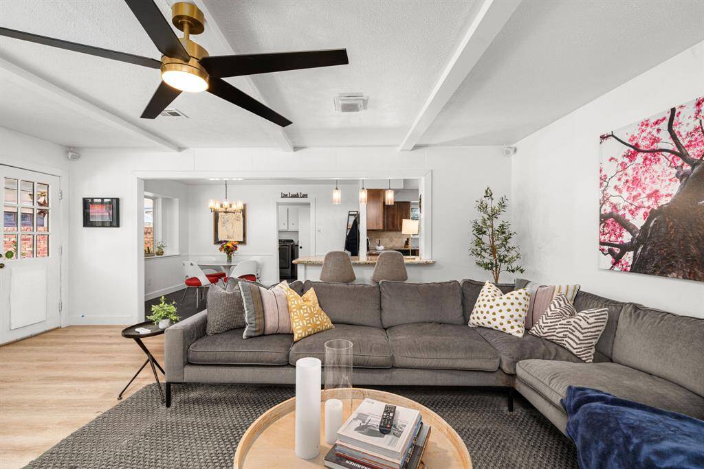 Family room has access to covered patio and pool. Flows into breakfast room and kitchen. Laundry room with powder bath is visible in rear center of this picture, beyond breakfast room