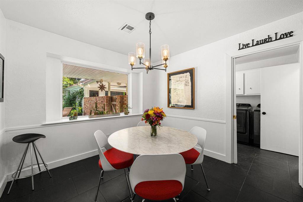 Breakfast area next to laundry room and powder bath has door to covered patio to garage.