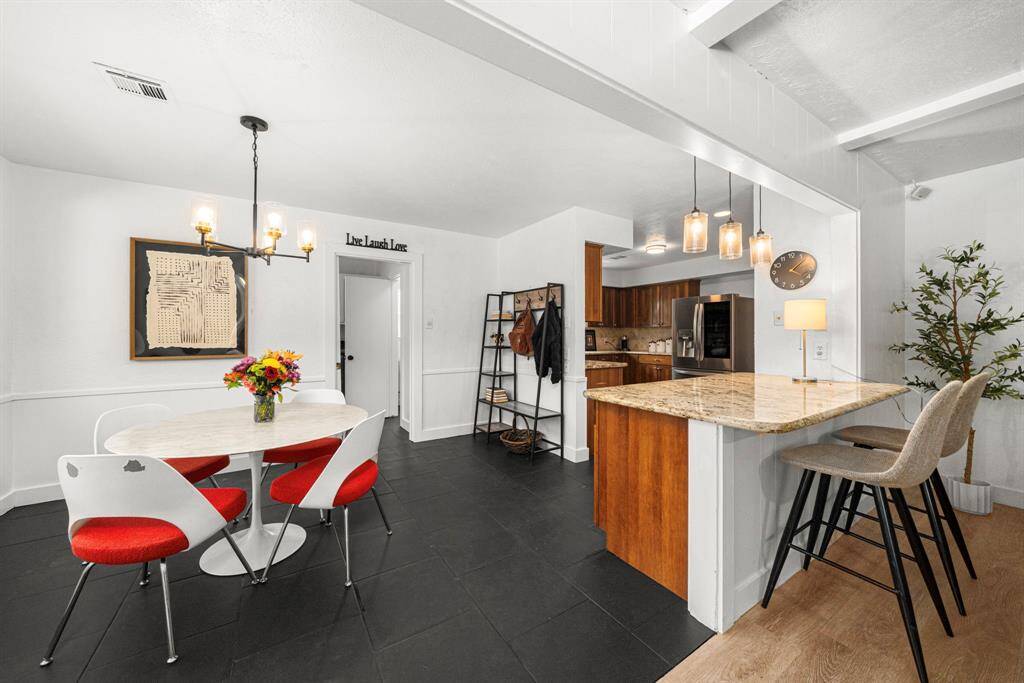 Breakfast area has black tile flooring
