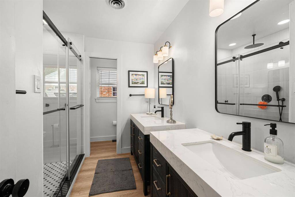Updated hall bath features double sinks, large shower