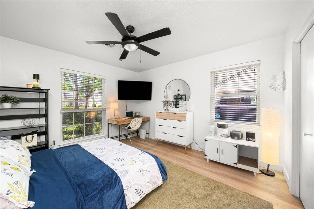 Bedroom #3 has white oak luxury vinyl tile floors and neutral paint