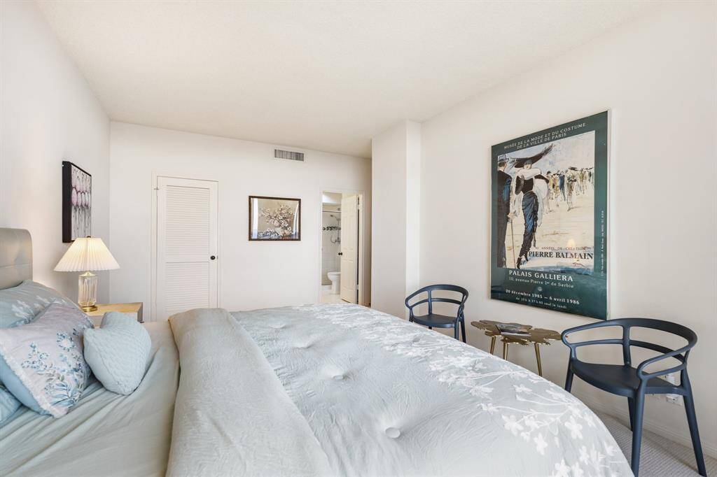 Primary suite with walk-in closet and private bathroom.