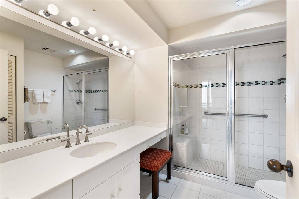 Primary bathroom with walk-in shower and vanity area.