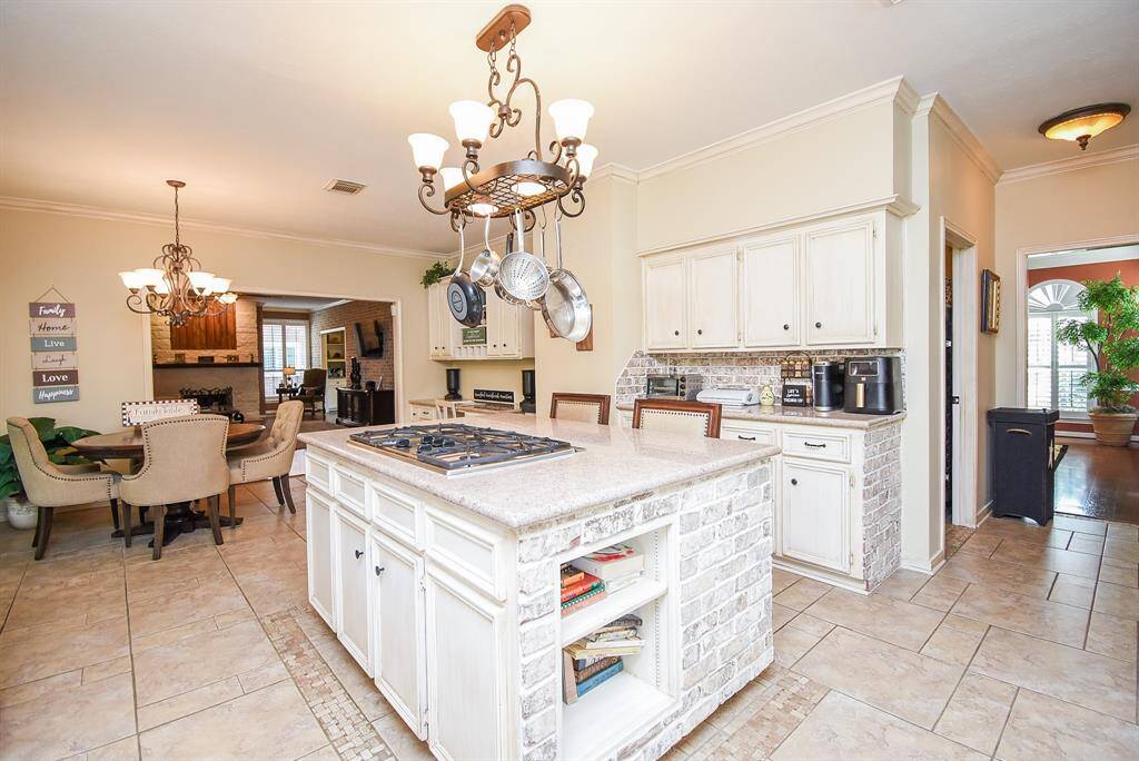 Large kitchen with natural gas range installed in the island