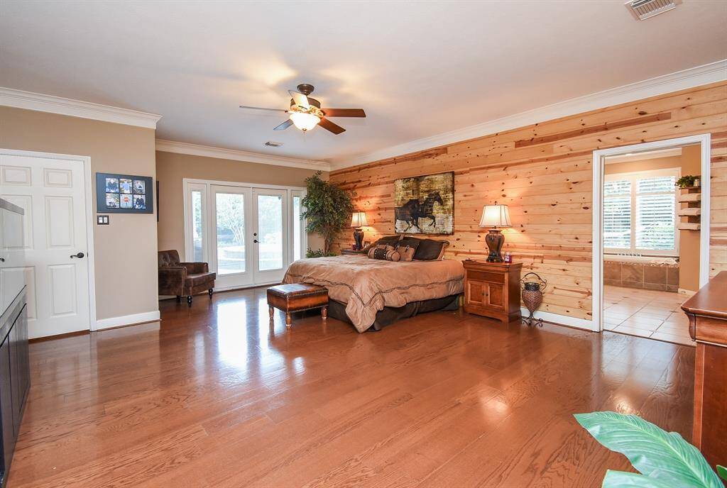 Double french doors added in the Primary Bedroom leading to the pool.  This was added aftermarket. Real wood added to back wall