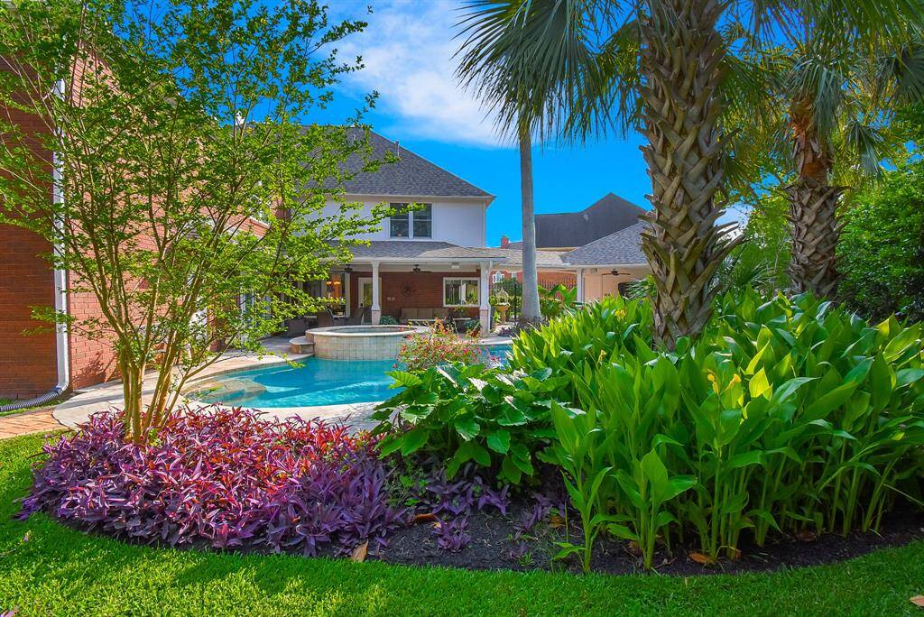 Looking back at the pool area from the massive backyard