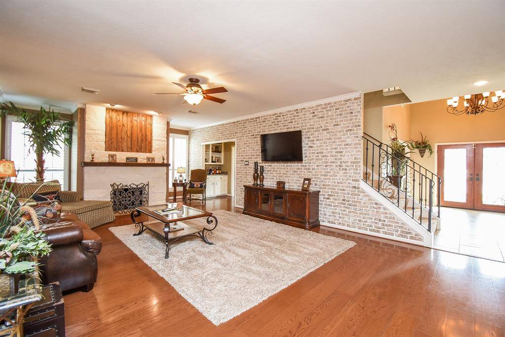 Large Family room with brick walls and limestone fireplace