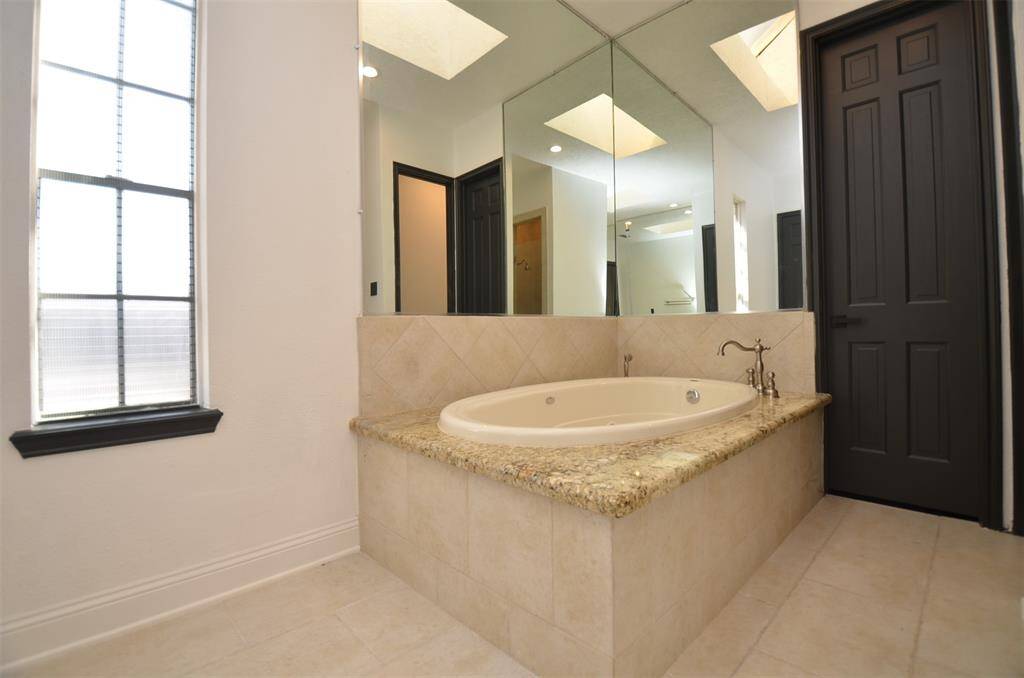 The primary bathroom includes a relaxing jacuzzi tub, making your own spa experience at home a reality.