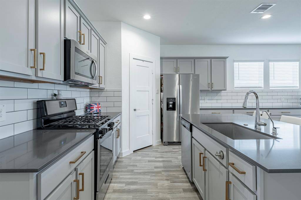 Sleek cabinetry and stylish backsplash add a polished touch to the heart of the home.