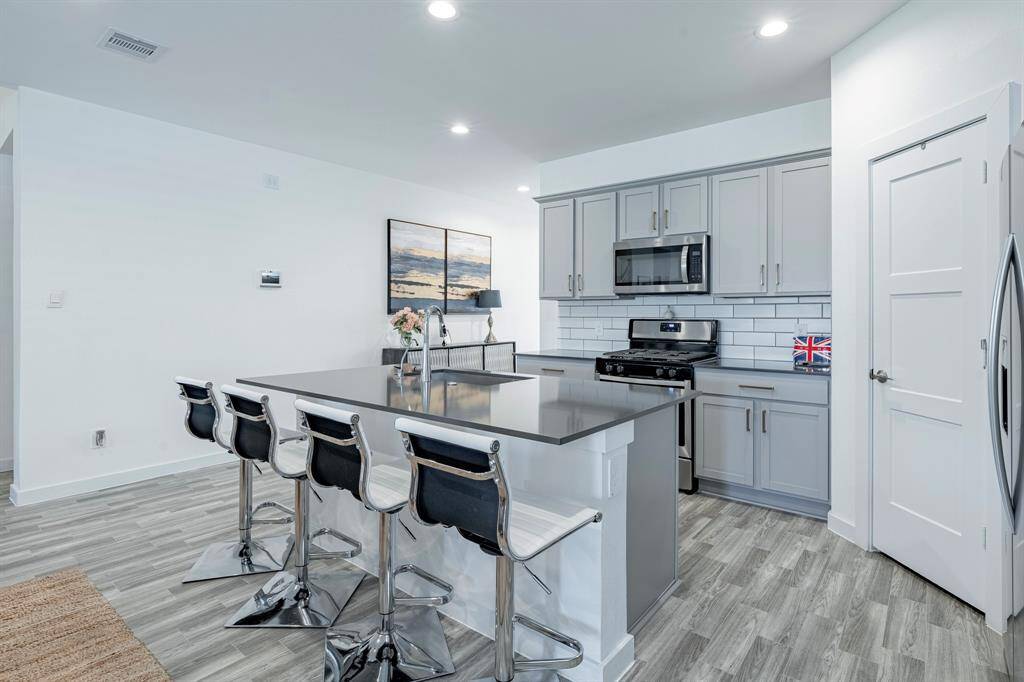 Large island with bar seating invites casual meals and conversation.