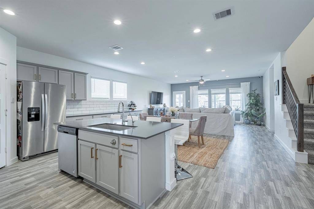 Open-concept layout connects the kitchen to the living and dining areas for effortless entertaining.