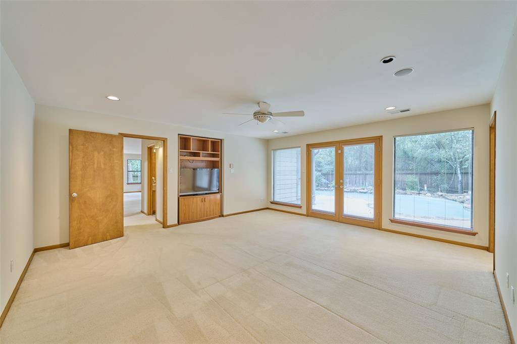 Large windows and french doors overlooking sparkling pool & spa
