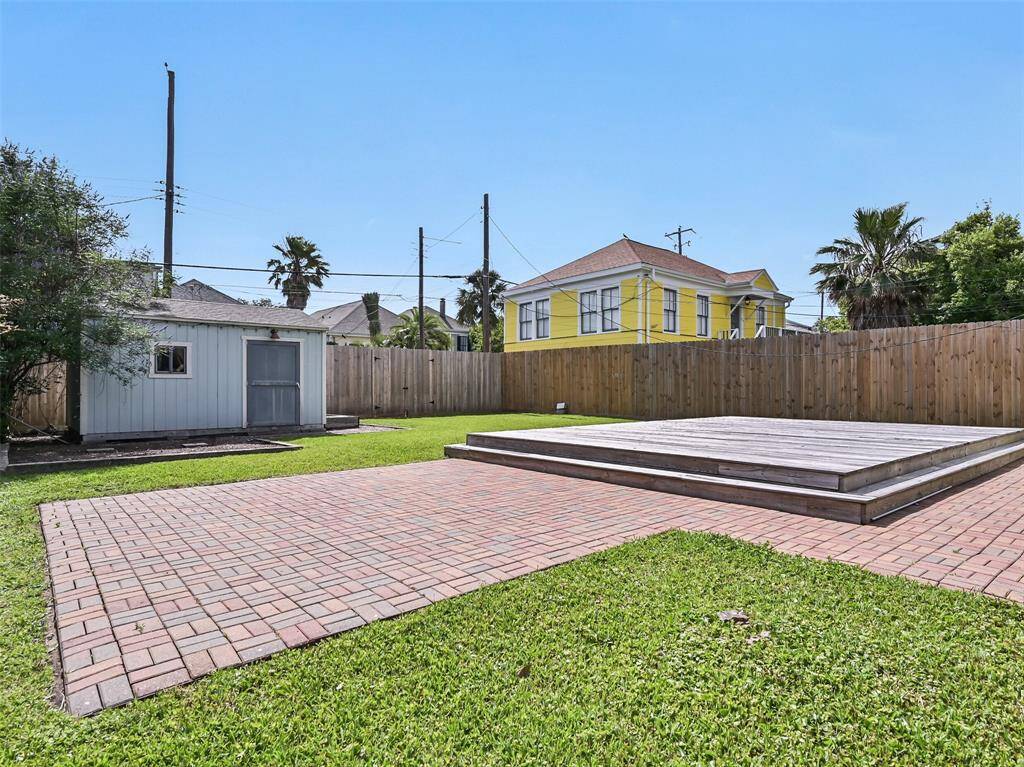 The backyard features a 900 sq ft brick patio with raised wooden deck.