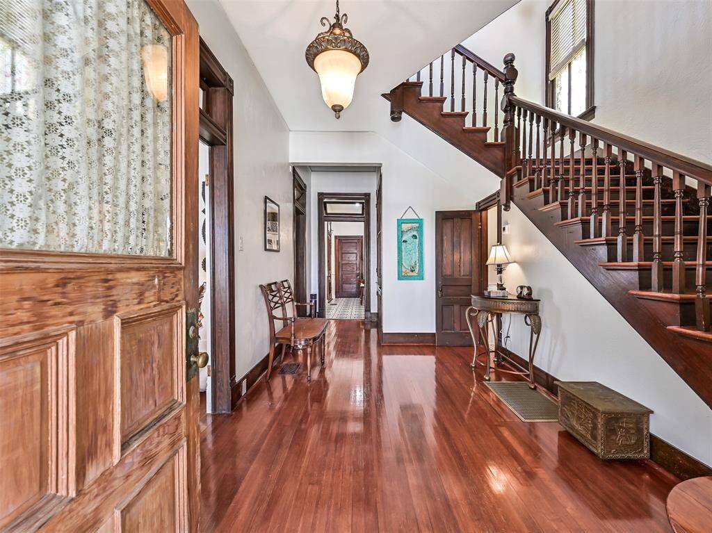 Entry hall showcasing beautiful hardwood floors and equisite wood trim.