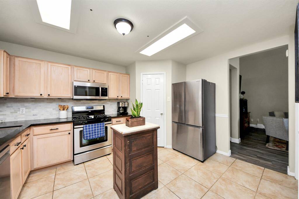 The kitchen opens seamlessly to the living room, creating a functional flow ideal for entertaining and everyday living.Please note: the kitchen island is not included with the home.