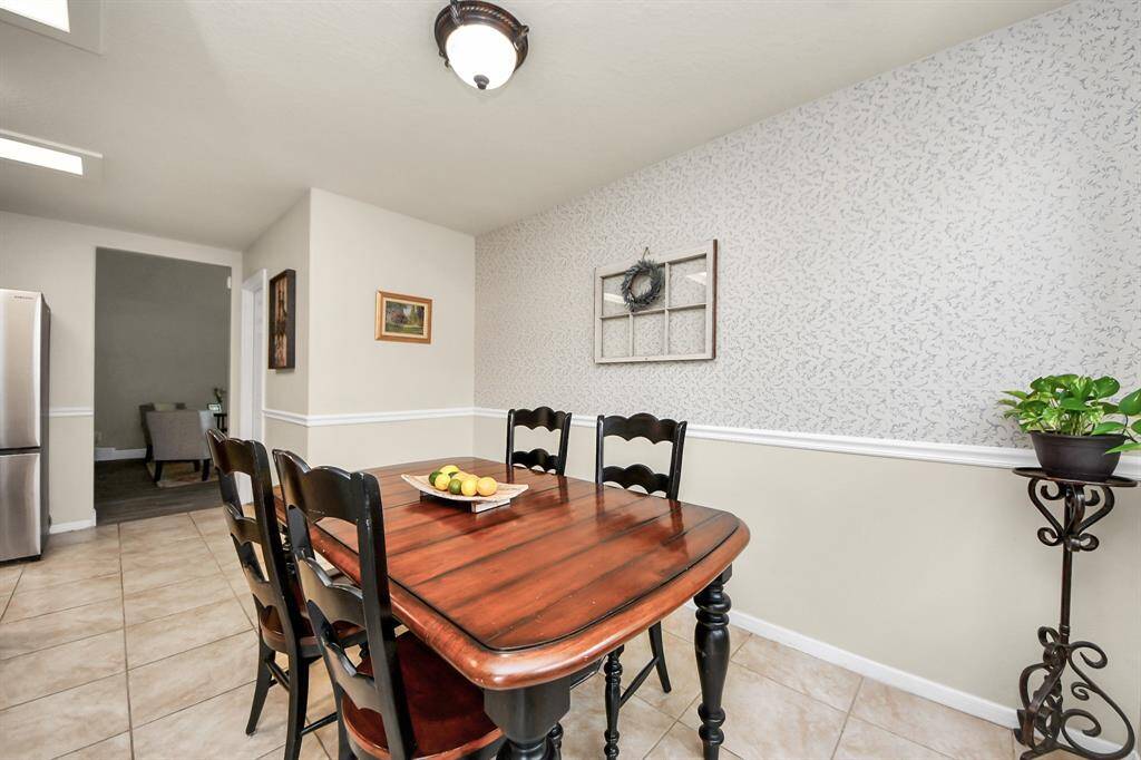 This charming space features ample natural light, neutral tones, and plenty of room for a family-sized table.