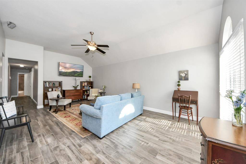 Step into this spacious living room featuring stylish tile-look flooring and fresh neutral paint throughout.
