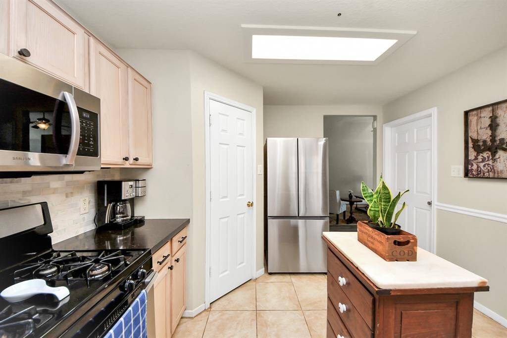 A walk-in pantry offers ample storage, and while the kitchen island adds extra prep space and charm, please note that the island does not stay with the home.