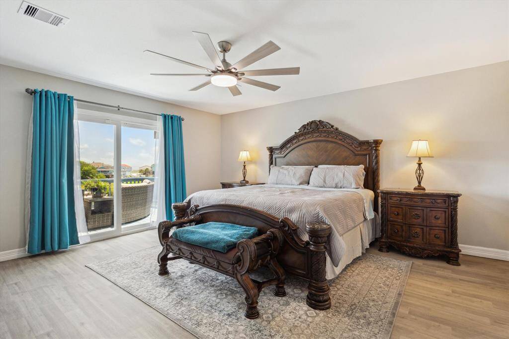 Your primary bedroom is very spacious and there's a sliding door that leads to the patio. You can see the bay in the distance. Can you imagine waking up to this view!? It will be cheery in the morning as the sun rises over the water.