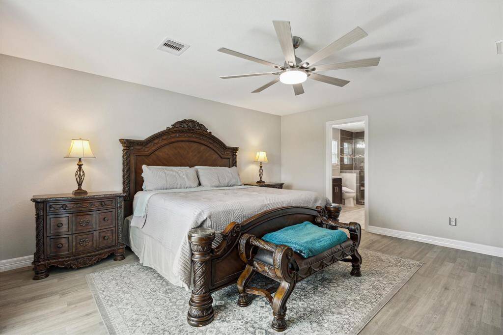 You have plenty of room for oversized bedroom furniture and there's an en-suite bath you can peek at. Check out the 8-blade upgraded ceiling fan.