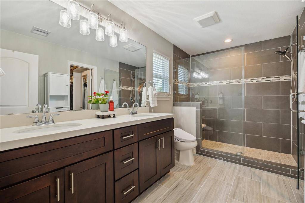 Your bath also has quartz countertops and a spacious tiled shower with a bench.