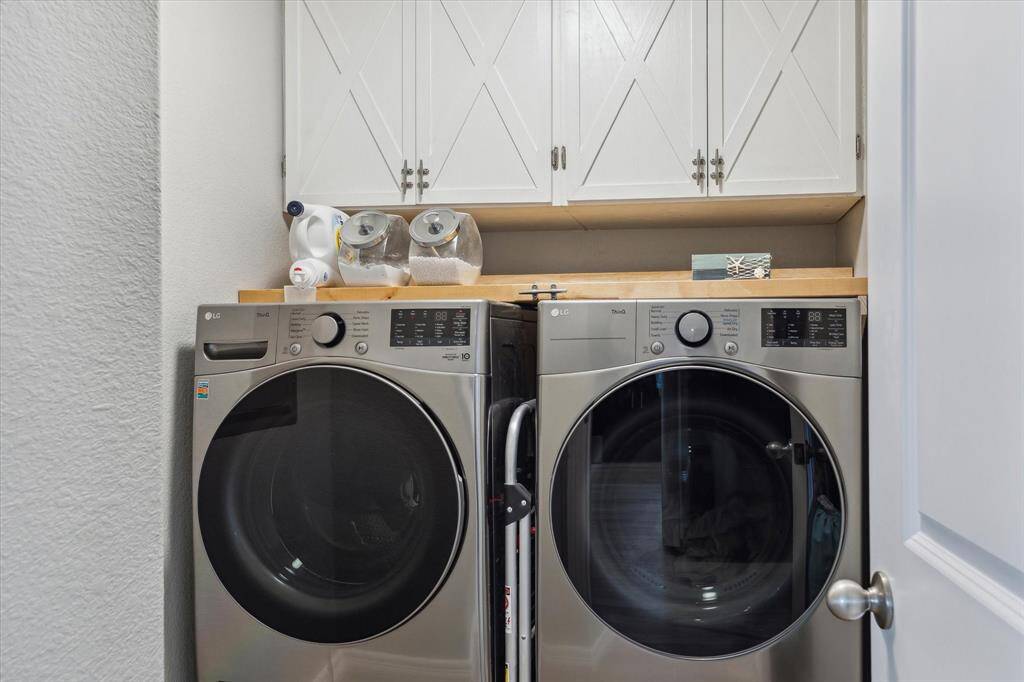 Your laundry room is compact, but has some really cool features. There are cabinets above the appliances for extra storage and the brown shelf pulls forward so you can actually reach the things on top! It's fabulous! You can use all the space and have access without a stool. There's a back on the shelf so you don't lose things over the edge. This home is all-electric.