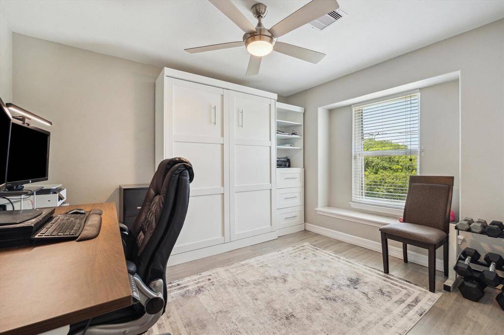 This bedroom is to the left as you enter the house. It's over the garage. It is being used as an office and the seller works from home so as much notice as possible before showings is appreciated. There's a standing Zoom between 12-1, so no appointments can be approved on work days. That cabinet is actually a Murphy bed!