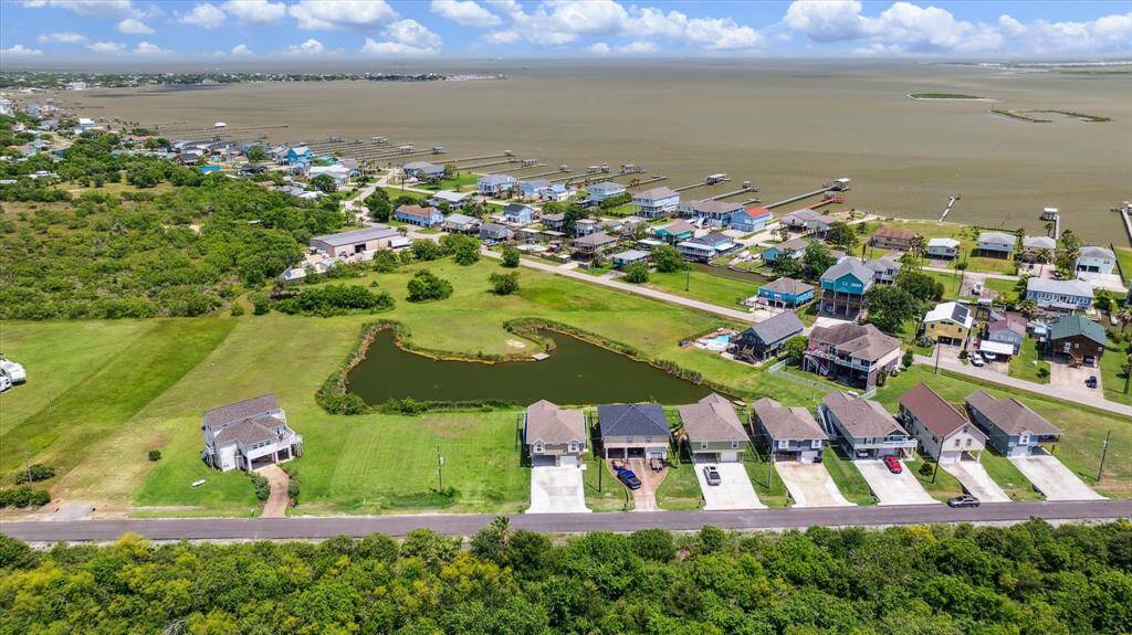 Here's an aerial view showing your primo location on the community pond and your proximity to the bay. There's not an HOA now, but if Avenue P is ever developed at some point in the future, Phases 2 & 3 may be built and an HOA will be created. Many of the Ph 2 lots area landlocked, so it may be a long, long time before anything can be built.