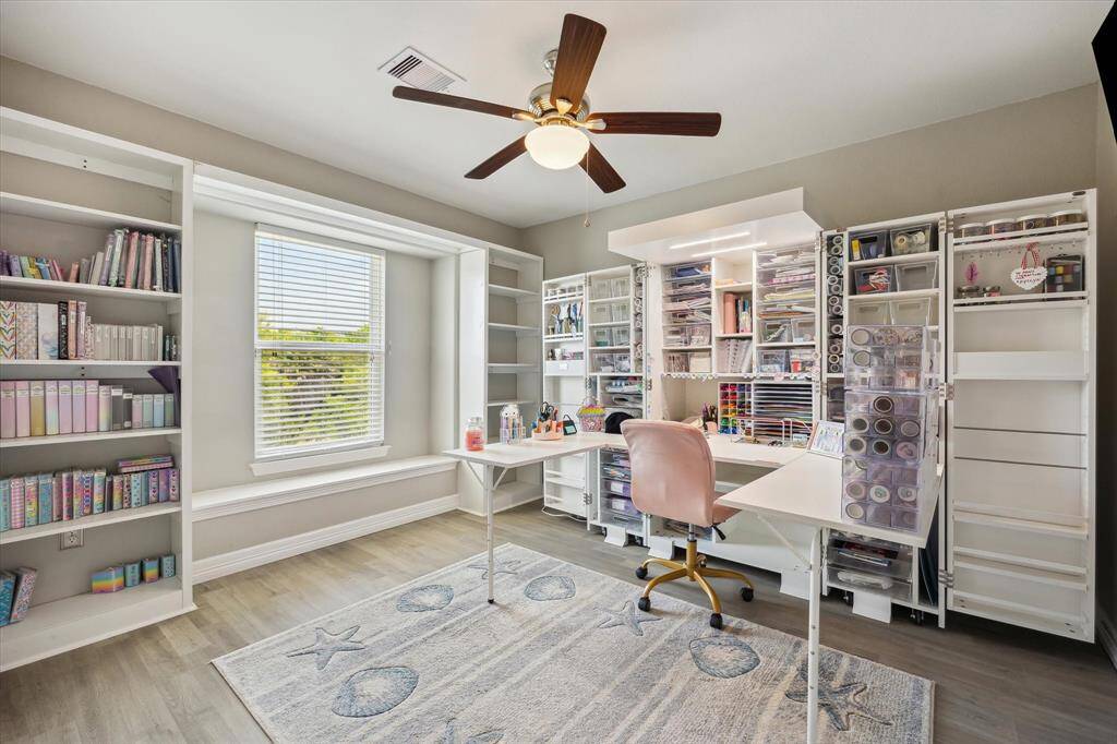 This is the right rear bedroom when you come into the living room. It's over the carport below. This dreamy crafts cabinet does not stay, but the two built-in bookcases on either side of the window seat are a custom upgrade.