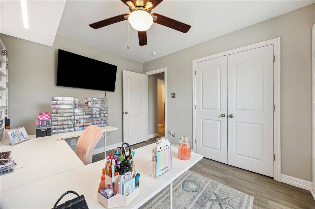 Here's another peek at the third bedroom that is now being used for crafts. The reach-in closet is shown here with double doors. The hall bathroom is behind this closet. The TV brackets will stay, but the TVs will go.
