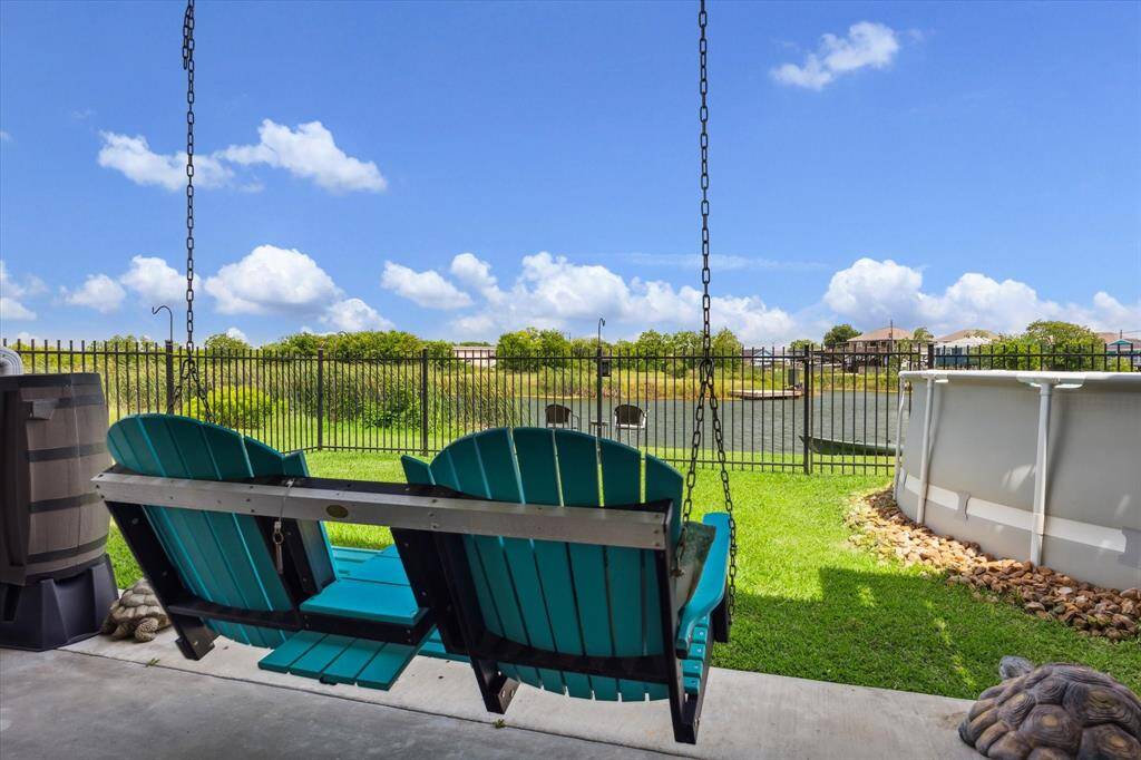This swing is downstairs and it doesn't stay, but it gives you a great idea of what you can do when it's YOUR place! You have a pretty wrought-iron fence to define your space and there's a rain barrel at the end of the gutter for watering your plants.