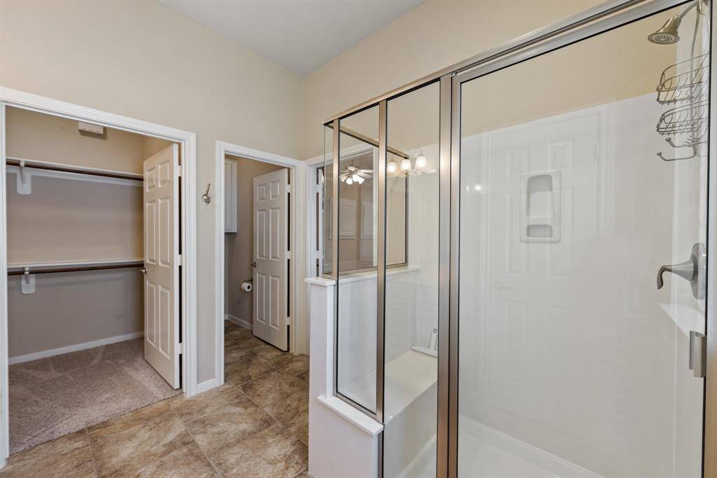 The bathroom also features a spacious walk-in closet for ample storage.