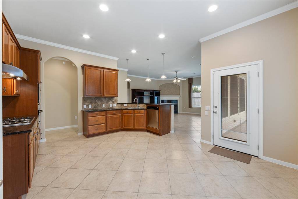 An exterior door directly from the kitchen area leads to a screened-in porch, offering a shaded retreat with views of the backyard