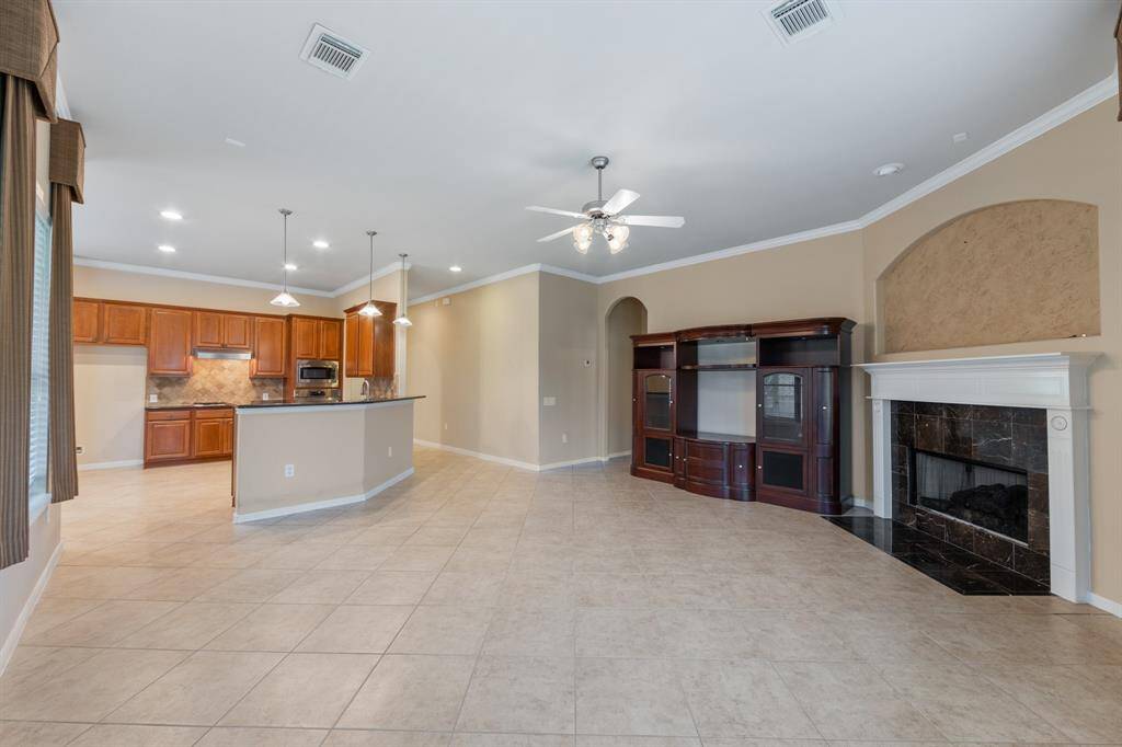 The open layout seamlessly connects the kitchen to the living room, creating a spacious and airy environment perfect for entertaining and everyday living.