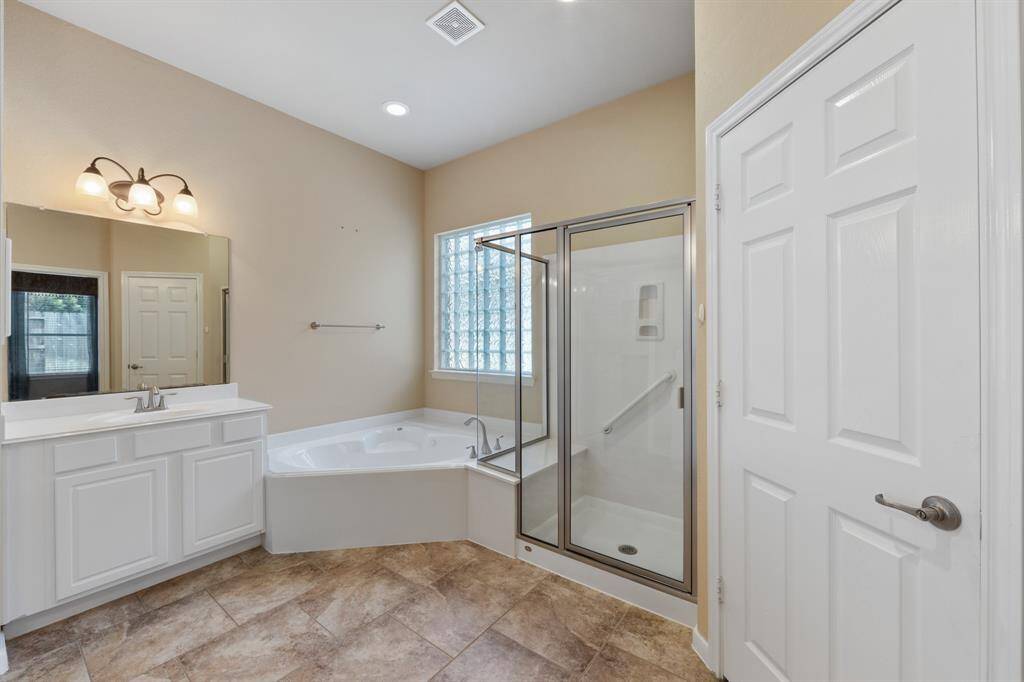 The jacuzzi tub is perfectly positioned just beneath the window.