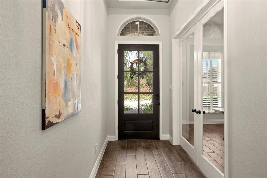 This modern bathroom boasts neutral tones, light cabinetry, and abundant natural light, creating an elegant spa-like retreat.