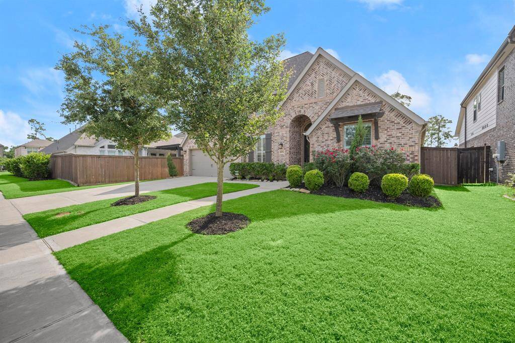 Discover this charming brick home with a beautifully manicured front yard, vibrant greenery, and trees. Enjoy a welcoming arched entryway, spacious driveway, and serene neighborhood setting.