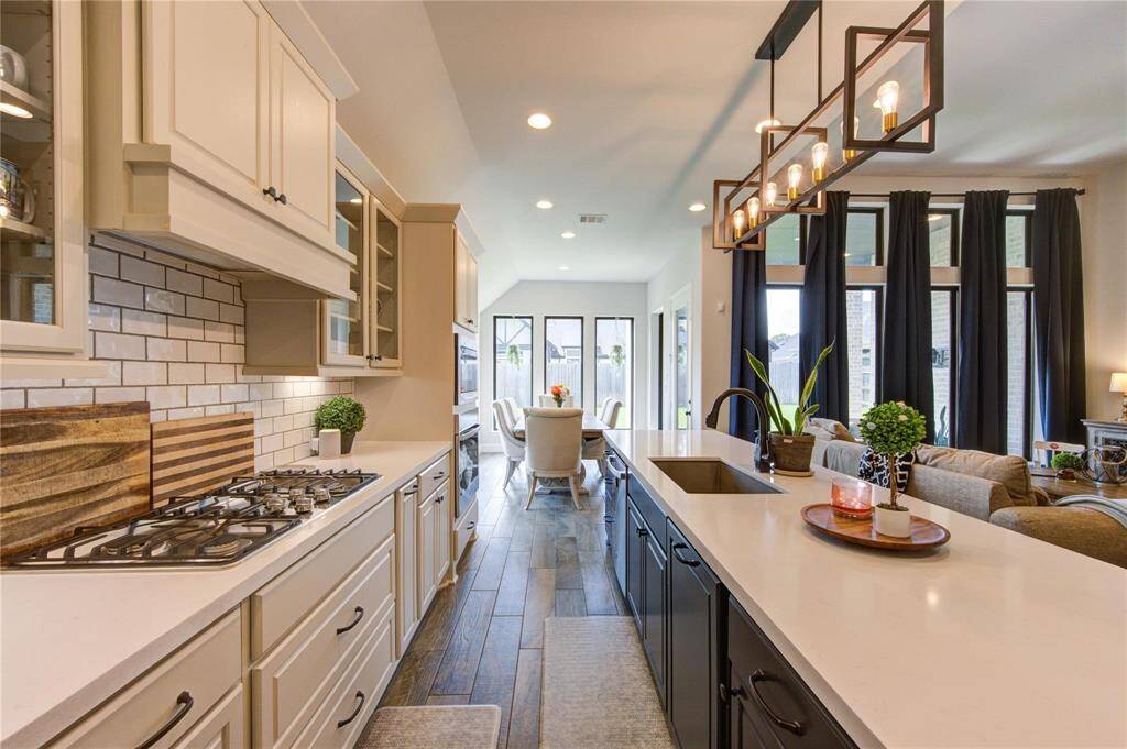 The beautiful kitchen contains many upgraded features and opens to the living area, creating a spacious and inviting atmosphere.