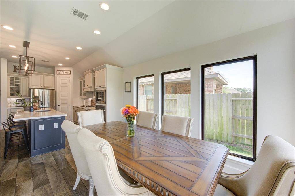The spacious dining area opens to the kitchen and living room, making it ideal for family dinners or entertaining guests
