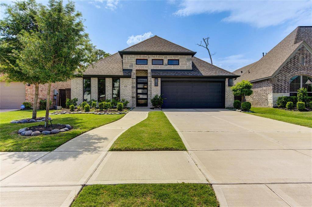 In a quiet section of the neighborhood, this home features a simple, neatly landscaped front yard that is welcoming to its owners