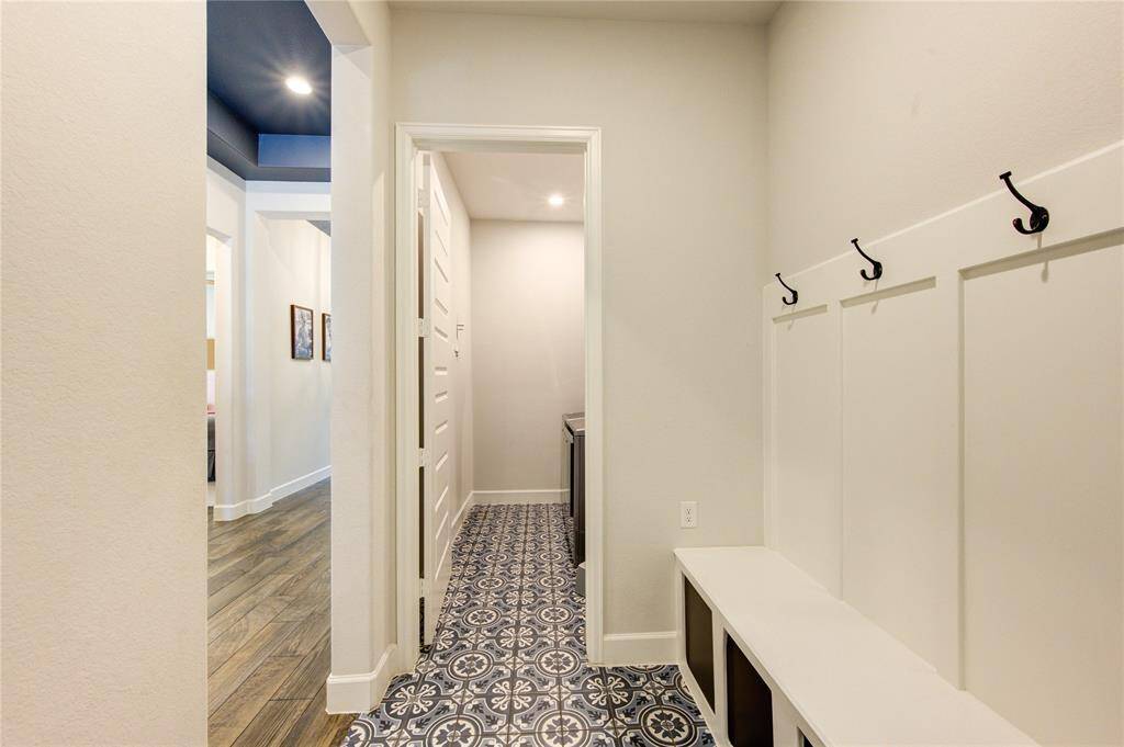 Functional mud room leading to laundry and main hallway