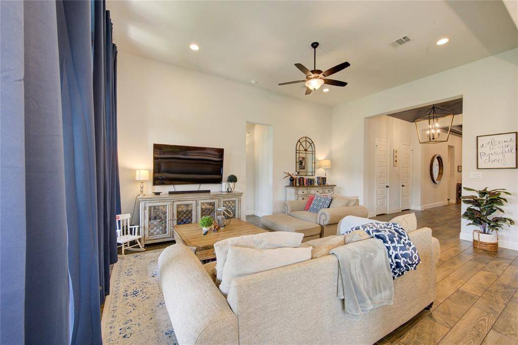 Living area with floor to ceiling windows and custom curtains