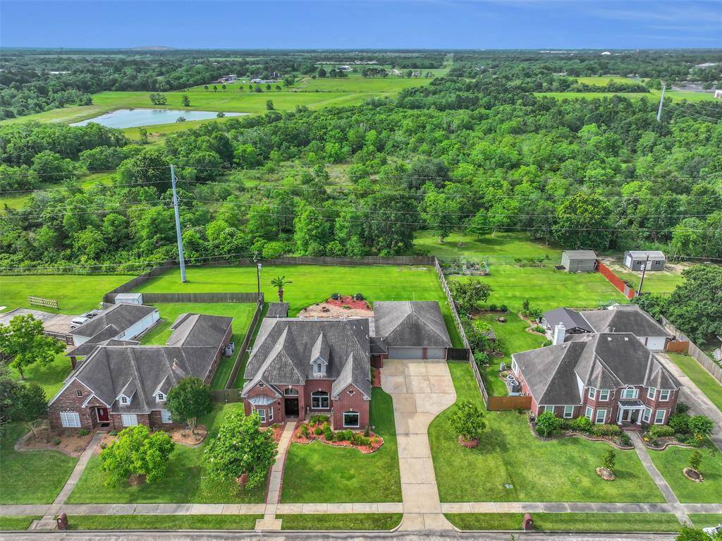 North-facing home on an expansive 0.58-acre lot with no rear neighbors—offering serene privacy and uninterrupted views of lush green space. A rare combination of space, orientation, and seclusion in Friendswood ISD.