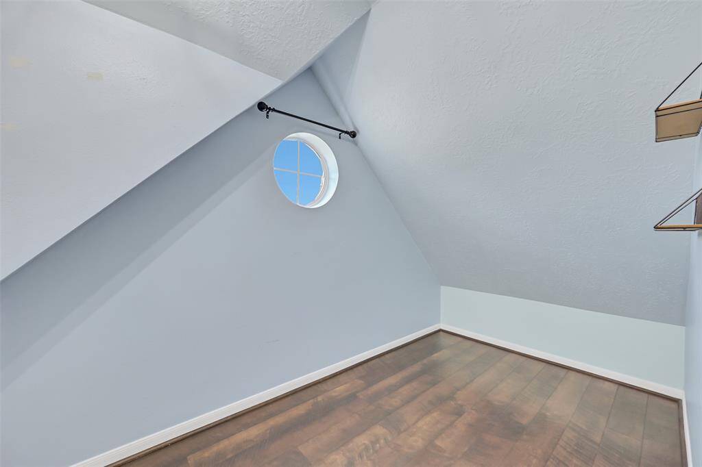 Spacious walk-in closet with built-in shelving and a hidden doorway leading to a bonus storage space—an ideal solution for seasonal items, keepsakes, or creative use of tucked-away square footage.