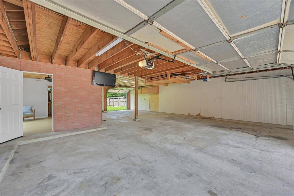 This expansive 5-car tandem garage offers exceptional versatility, with direct access to the pool cabana and full bathroom—perfect for entertaining or a future workshop conversion. Dual garage doors and ample storage potential make it both functional and spacious.