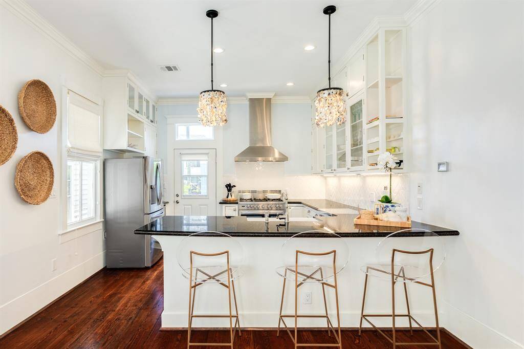 Open Kitchen area with Lucite Stools Oyster Pendent Lights